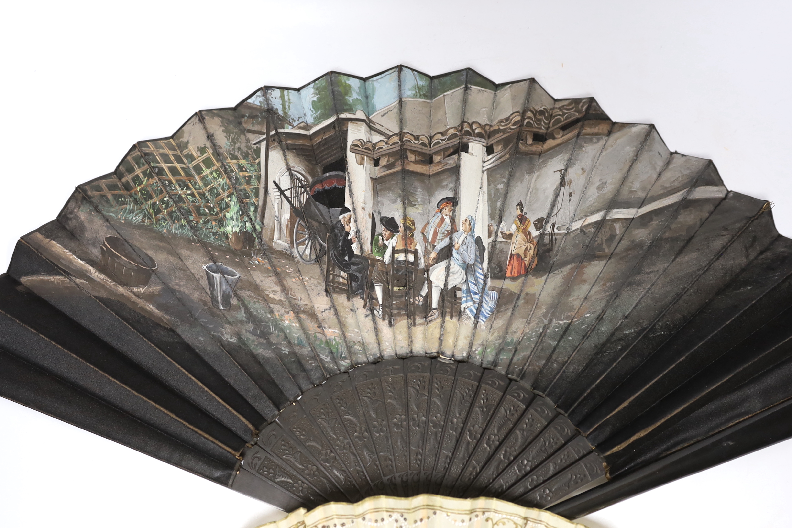 A French 19th century bone and sequin fan and a Spanish figurative leaf fan with ebony guards